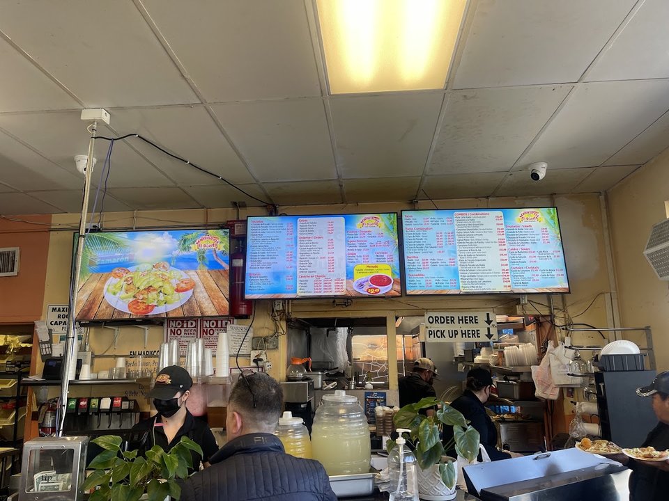 Colorful mariscos dishes with lime and salsa.